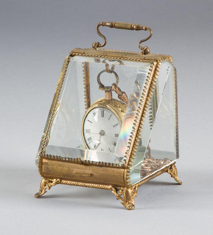 Unique and ornate, brass and beveled glass, footed Watch Display, measures 4" T x 3 1/2" W, with han