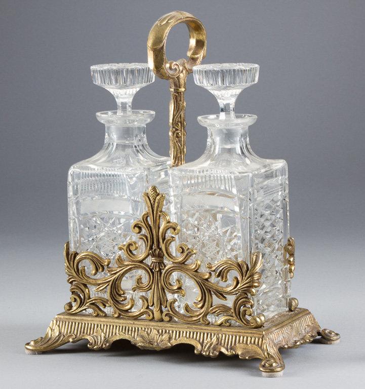 Ornate Tantalus on footed base with handle and two 3 1/2" square Crystal Liquor Bottles with ground