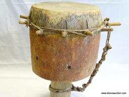 DRUM, BADIMA BUNTIBE, CIRCULAR HOLLOWED OUT HARD WOOD IMPALED WITH ANIMAL SKIN USING WOODED PEGS,
