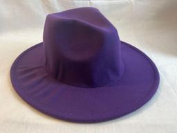 Lot of four wide brimmed hats. One purple with yellow inside, three black with red inside....