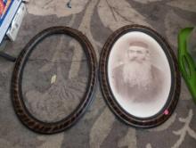 (LR) LOT OF (2) ANTIQUE OVAL WOOD FRAMES. ONE HAS A PICTURE OF AN OLDER MAN. THEY MEASURE 22-1/2" X