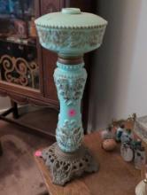 (LR) ANTIQUE CELADON GREEN GLASS LAMP WITH BROWN LEAF ACCENTS, STANDS ON A METAL BASE. IT MEASURES