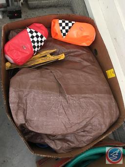 Box containing tent spikes, tarp, and water floaties