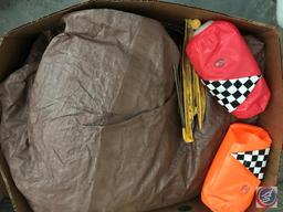 Box containing tent spikes, tarp, and water floaties