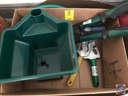 Box containing Ace Green Turf seed spreader, and gardening tools