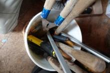 BUCKET OF TOOLS HEDGE TRIMMERS STAPLERS AND MORE