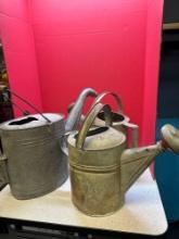 three galvanized watering cans