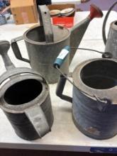 five galvanized water cans