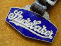 OLD "STUDEBAKER" ADVERTISING WATCH FOB WITH LEATHER STRAP