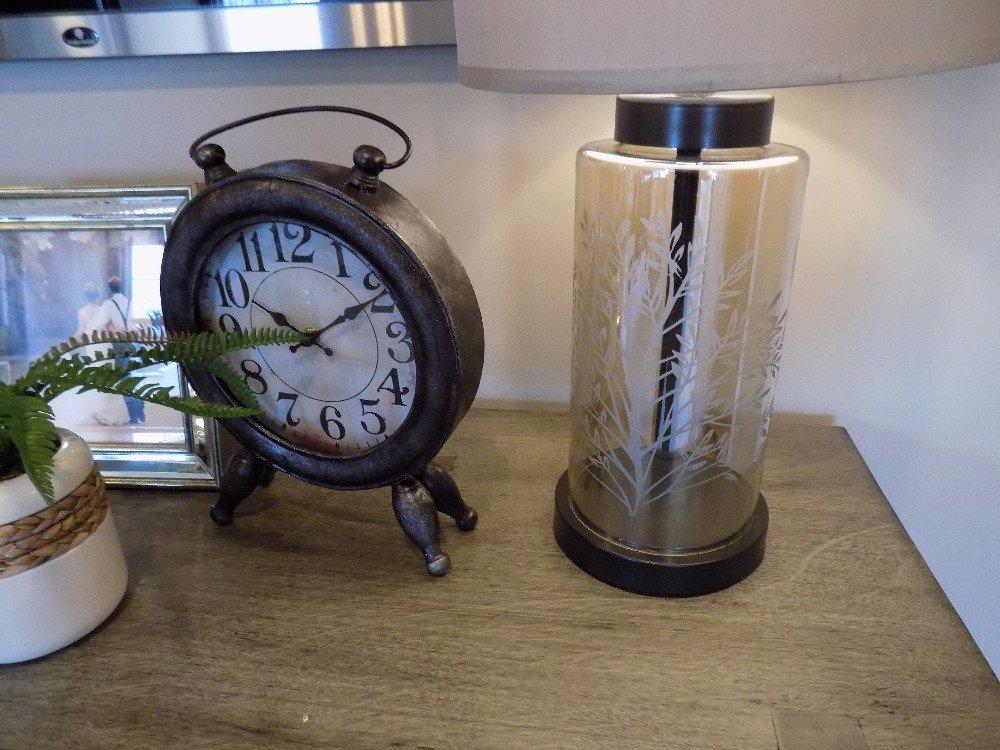 Glass lamp, red jar, and clock
