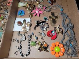Group of assorted costume jewelry, pins, necklaces, brooches and earrings