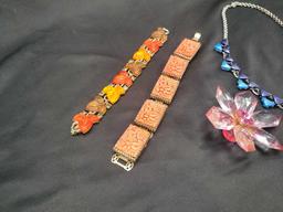 Colorful plastic costume jewelry bracelets, necklace and brooch