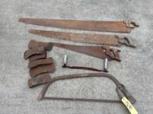 Assorted hand saws and ax heads