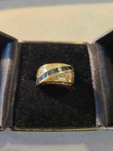 Lady's 14k yellow gold ring with 9 square blue sapphires