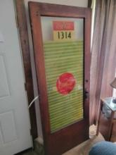 Antique door with Coca Cola sticker decal