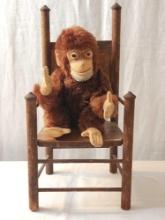 Vintage Steiff mohair monkey in early wooden doll chair