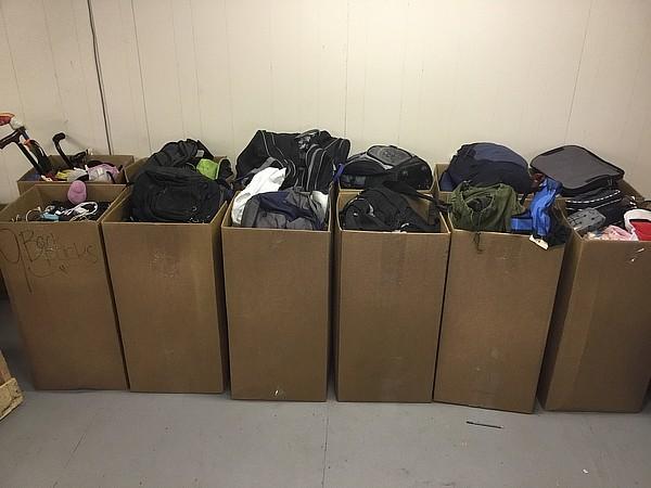 12 boxes of backpacks,clothes,purses,tools,electronics, Phone chargers and plugs,canes,
