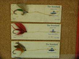 Display of 6 "The Standard" bass fly lures, each different